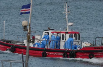 Health workers in protective gear arrive to evacuate patients from the MV Hondius cruise ship