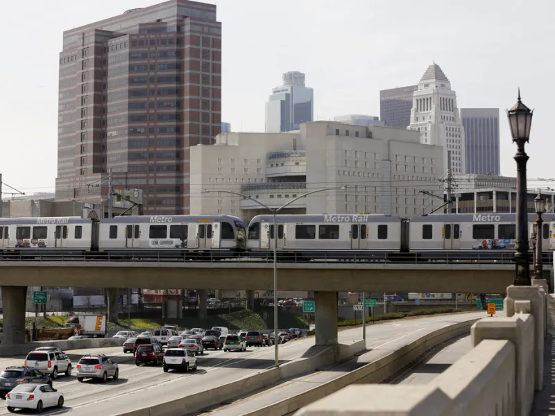 A Metro Rail light train on the Gold Line travels over the 101 Santa Ana Freeway near Union Station in Los Angeles