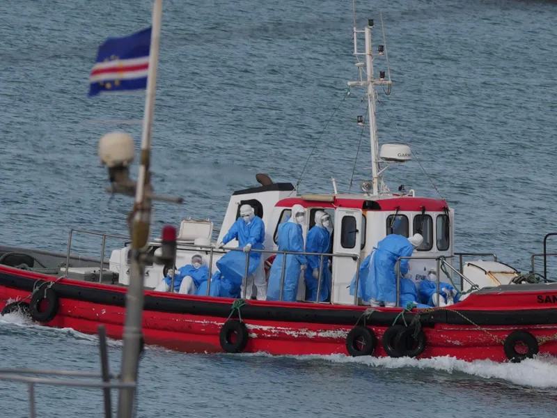 Health workers in protective gear arrive to evacuate patients from the MV Hondius cruise ship