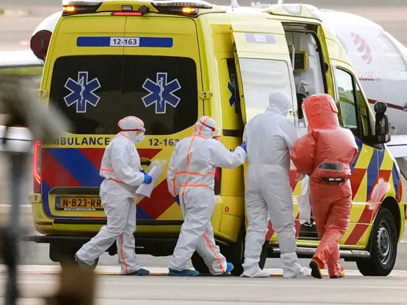 Medics escort a patient, second right, evacuated from the MV Hondius cruise ship with suspected hantavirus infection