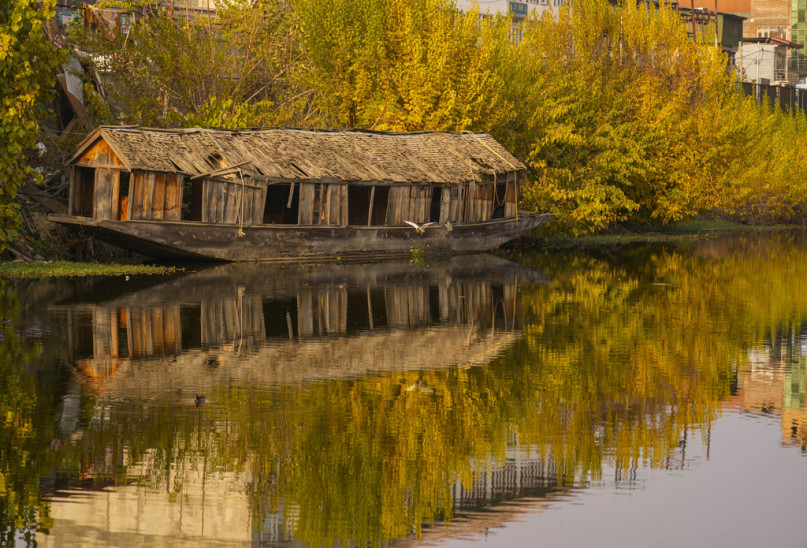 An old damaged house boat parked on the interior of Dal lake in Srinagar, Indian controlled Kashmir